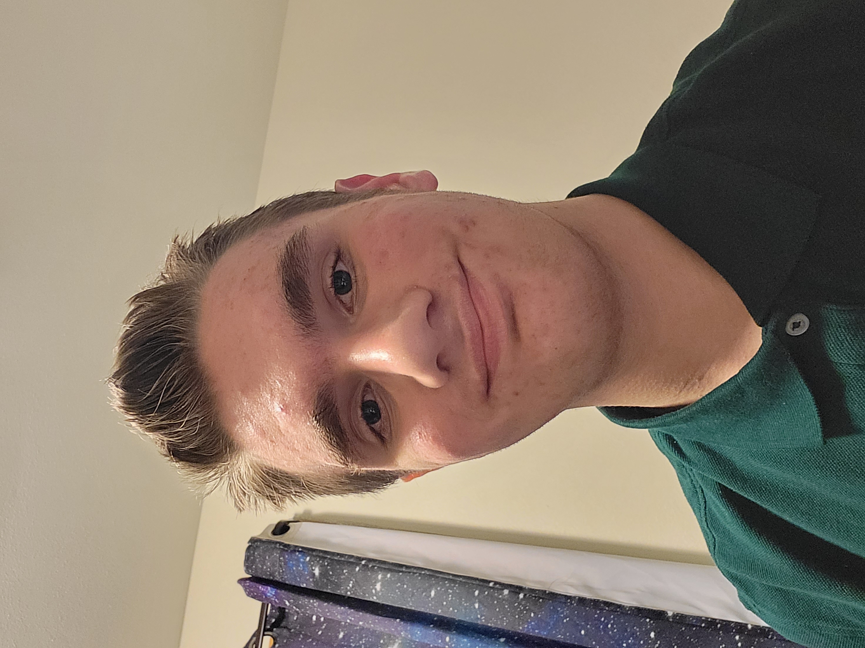 Nolan, the creator of this page, wearing a green polo shirt.