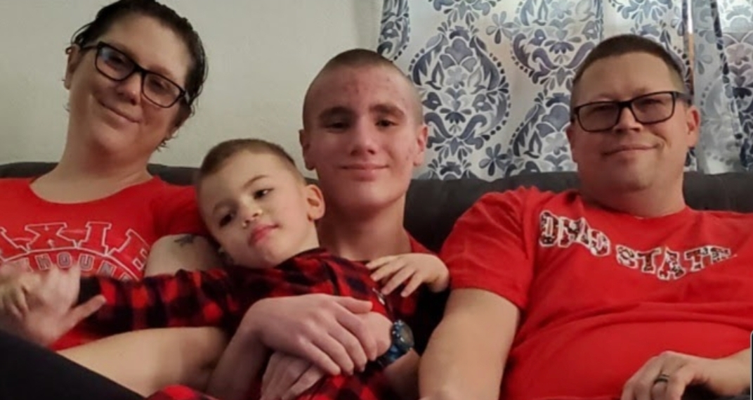 A picture of my mom, my little brother, my stepdad, and I.